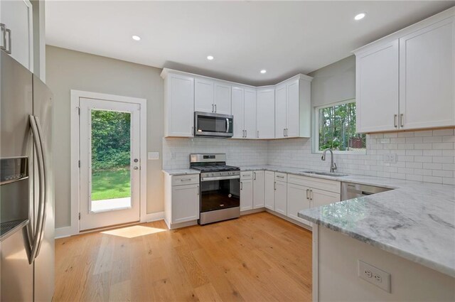 1857 Derrill Dr, Decatur, GA 30032 - kitchen featuring a sink, white cabinetry, light stone countertops, and appliances with stainless steel finishes