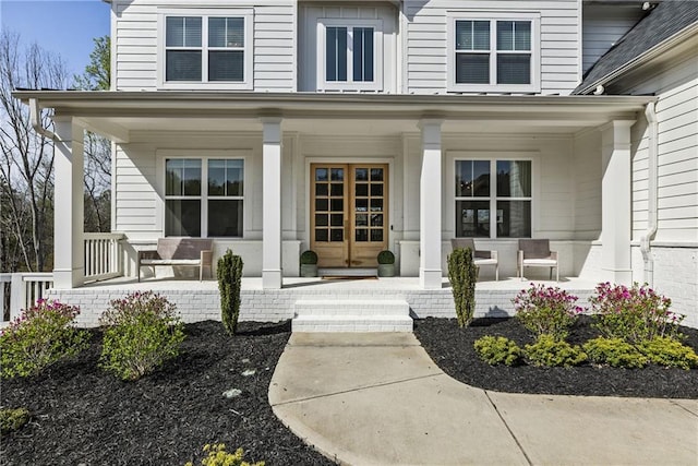 view of exterior entry with a porch
