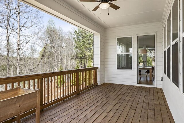 wooden deck featuring a ceiling fan