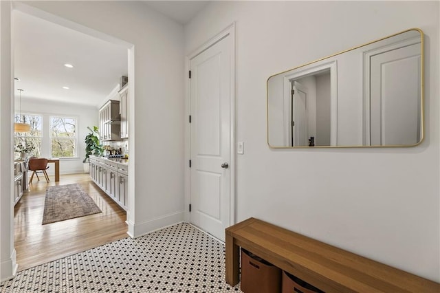 hallway featuring baseboards and recessed lighting