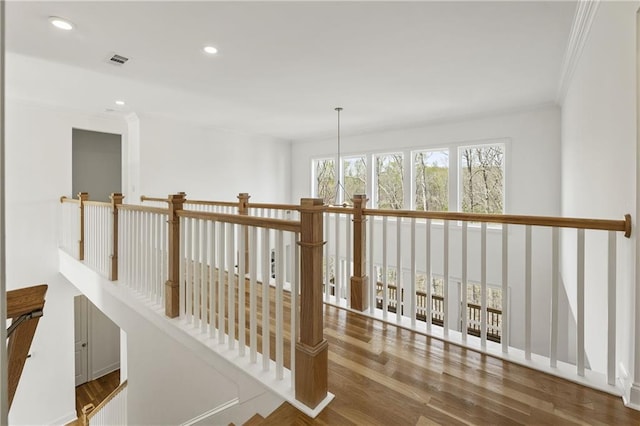 interior space with crown molding, visible vents, recessed lighting, and wood finished floors