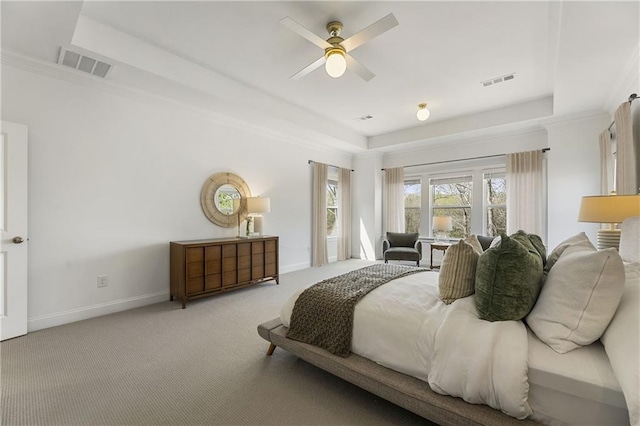 carpeted bedroom with visible vents, baseboards, and ornamental molding