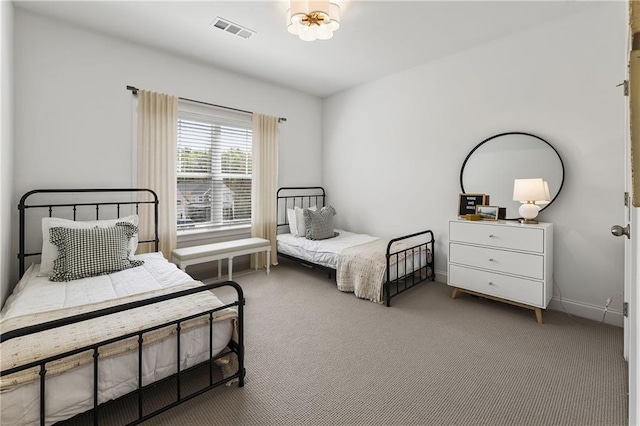 bedroom with carpet floors, baseboards, and visible vents