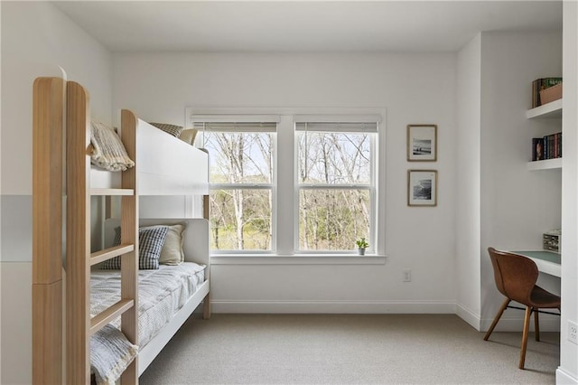 bedroom featuring carpet and baseboards