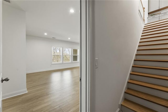 stairs with recessed lighting, baseboards, visible vents, and wood finished floors