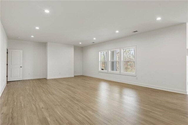 spare room featuring baseboards, recessed lighting, light wood finished floors, and visible vents