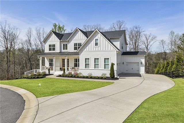modern farmhouse with board and batten siding, driveway, a garage, a front yard, and a porch