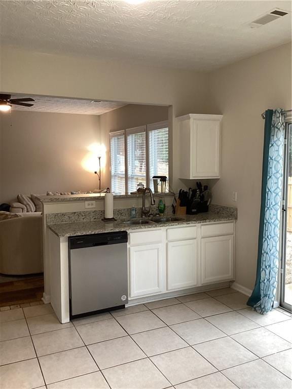 kitchen with visible vents, a sink, stainless steel dishwasher, open floor plan, and white cabinetry