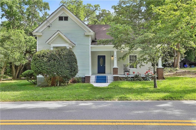 view of front of house featuring a front lawn and covered porch