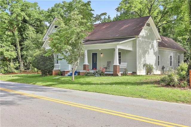 view of front of home featuring covered porch and a front lawn