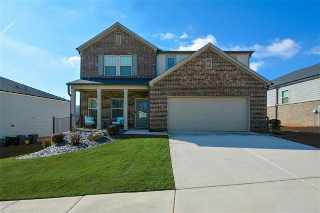 view of front of house featuring a garage, a front lawn, and covered porch