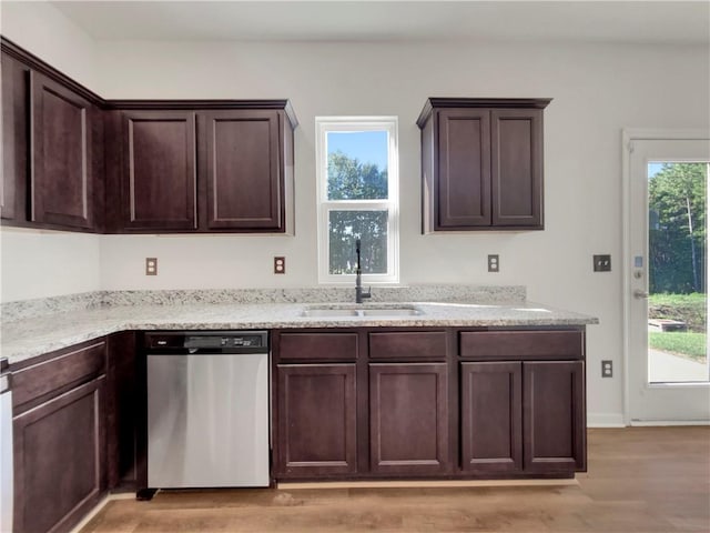 kitchen with dishwasher, a healthy amount of sunlight, sink, and light hardwood / wood-style flooring