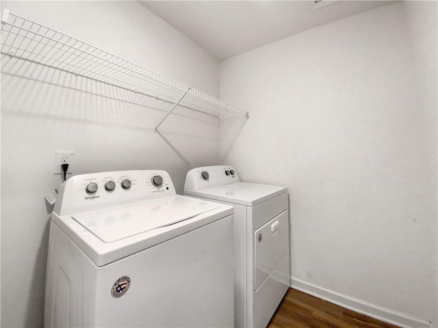 laundry room featuring dark wood-type flooring and separate washer and dryer