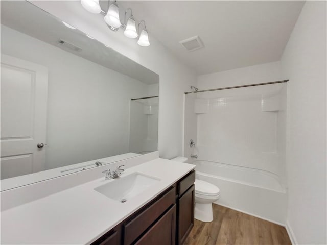 full bathroom with wood-type flooring, toilet, shower / bathing tub combination, and vanity