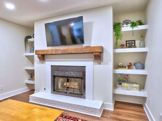 2210 Cumberland Ct SE, Smyrna, GA 30080 - detailed view of a fireplace with raised hearth, wood finished floors, recessed lighting, and baseboards