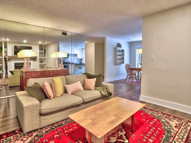 2210 Cumberland Ct SE, Smyrna, GA 30080 - living room with baseboards, a textured ceiling, dark wood-style flooring, and a fireplace