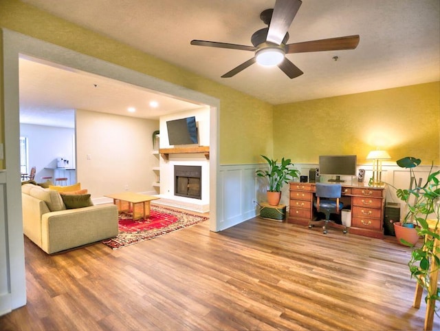 2210 Cumberland Ct SE, Smyrna, GA 30080 - office space with a fireplace with raised hearth, wood finished floors, a ceiling fan, and wainscoting