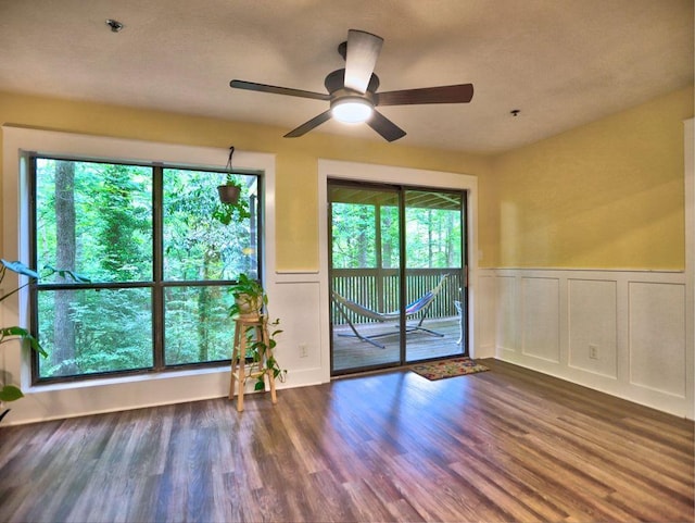 2210 Cumberland Ct SE, Smyrna, GA 30080 - spare room featuring a decorative wall, ceiling fan, wainscoting, wood finished floors, and fire sprinkler in ceiling