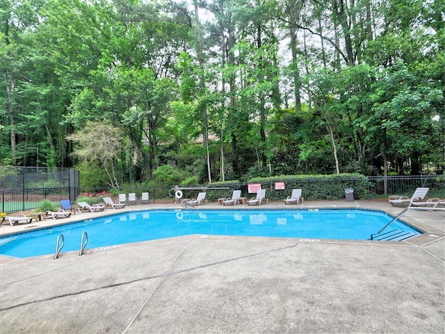 2210 Cumberland Ct SE, Smyrna, GA 30080 - community pool featuring a patio and view of scattered trees