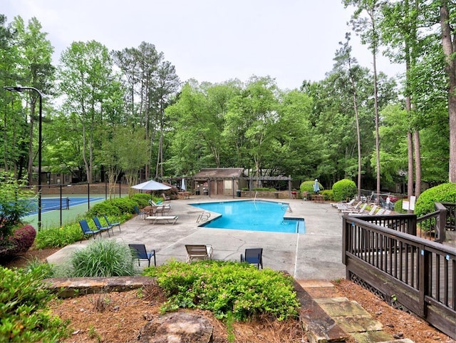 2210 Cumberland Ct SE, Smyrna, GA 30080 - community pool featuring a patio and view of wooded area