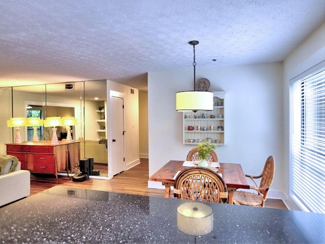 2210 Cumberland Ct SE, Smyrna, GA 30080 - dining room featuring wood finished floors, a textured ceiling, and baseboards