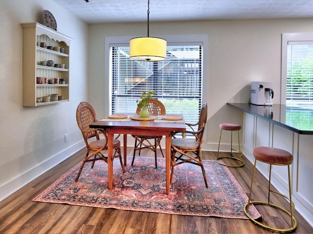 2210 Cumberland Ct SE, Smyrna, GA 30080 - dining area with wood finished floors, baseboards, and a textured ceiling