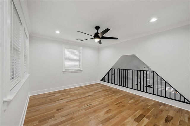 unfurnished room featuring crown molding, hardwood / wood-style floors, and ceiling fan