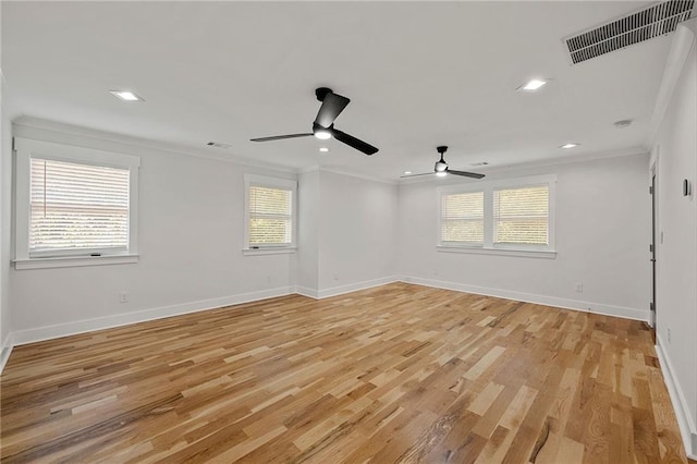 empty room featuring ceiling fan, baseboards, light wood-type flooring, visible vents, and ornamental molding