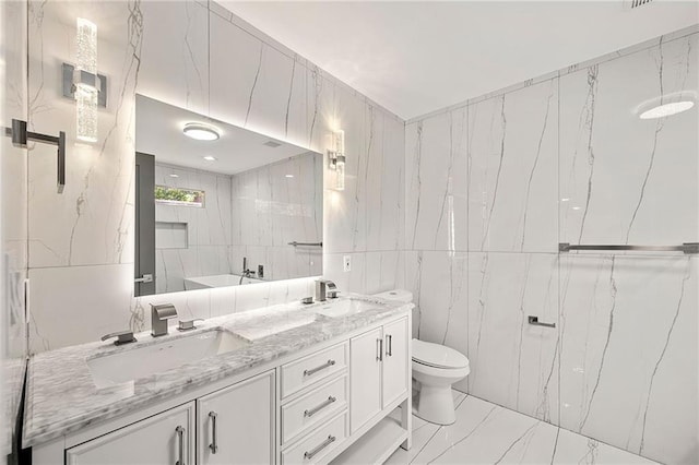 full bathroom featuring double vanity, tile walls, a sink, and marble finish floor