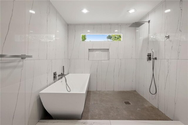 bathroom with a sink, a soaking tub, and a shower