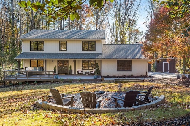 view of front facade featuring a fire pit, a storage shed, and a deck