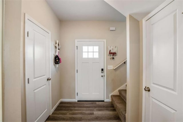 entrance foyer with dark wood-style flooring, stairway, and baseboards