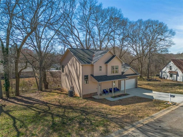 view of property exterior featuring central AC, a yard, and driveway