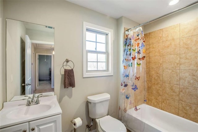 bathroom with visible vents, shower / bath combo, vanity, and toilet