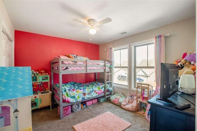 bedroom with carpet floors, a closet, visible vents, and ceiling fan