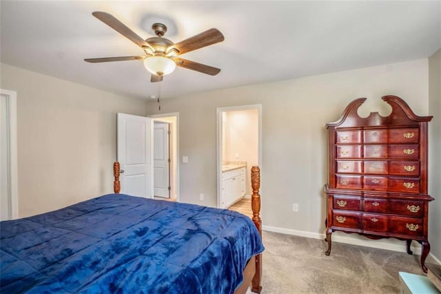 bedroom with a ceiling fan, light carpet, baseboards, and ensuite bathroom