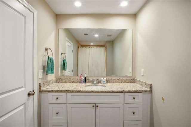 bathroom with recessed lighting and vanity