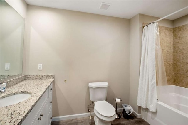 full bath with toilet, shower / bath combo, baseboards, and vanity