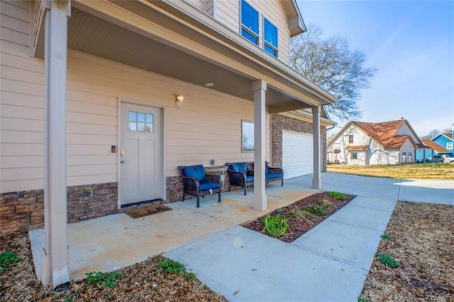 view of exterior entry with a garage and stone siding