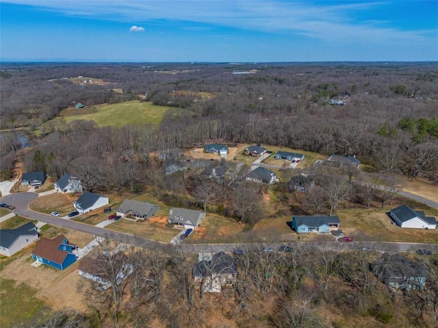 drone / aerial view featuring a wooded view