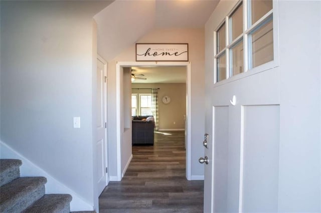 interior space featuring dark wood-style floors, stairs, and baseboards