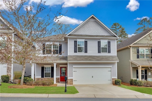 craftsman inspired home featuring a garage and a front yard