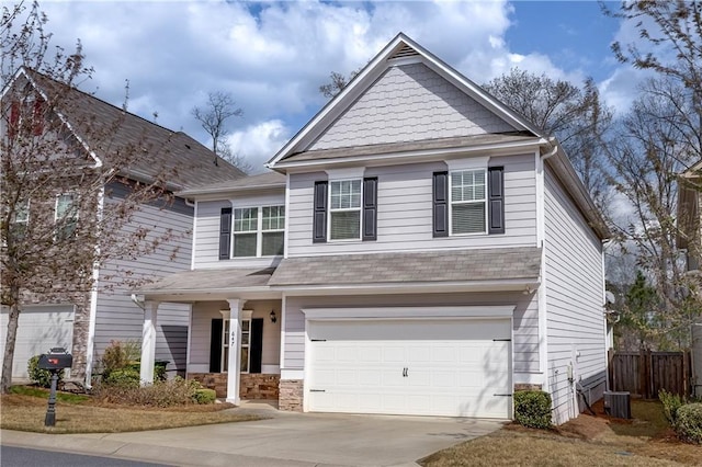 view of front of property with a garage and central AC unit