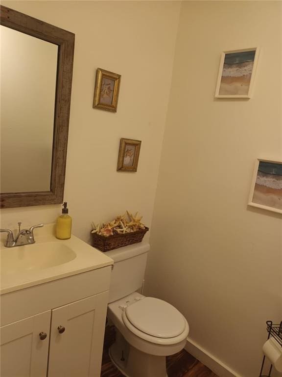 bathroom featuring hardwood / wood-style flooring, vanity, and toilet