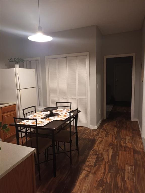 dining area with dark hardwood / wood-style flooring