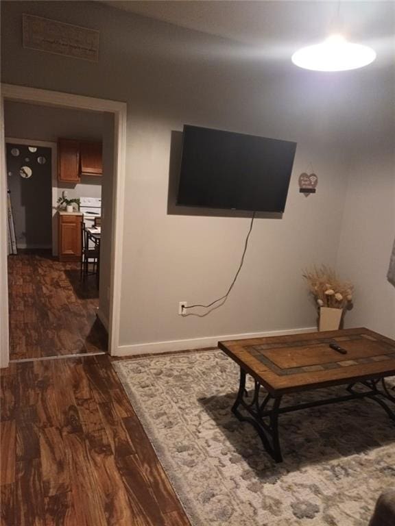 living room with dark hardwood / wood-style flooring