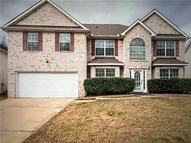 view of front of home with a garage and a front lawn