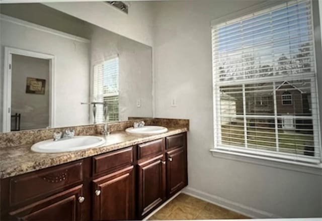 bathroom with tile patterned floors and vanity