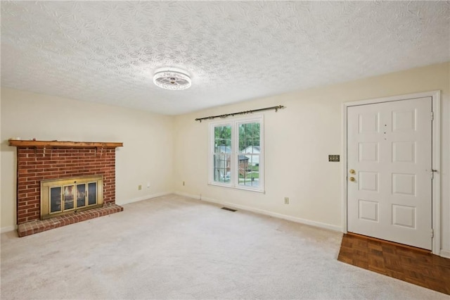 187 Timber Creek Ln SW, Marietta, GA 30060 - unfurnished living room featuring baseboards, a textured ceiling, a brick fireplace, and carpet
