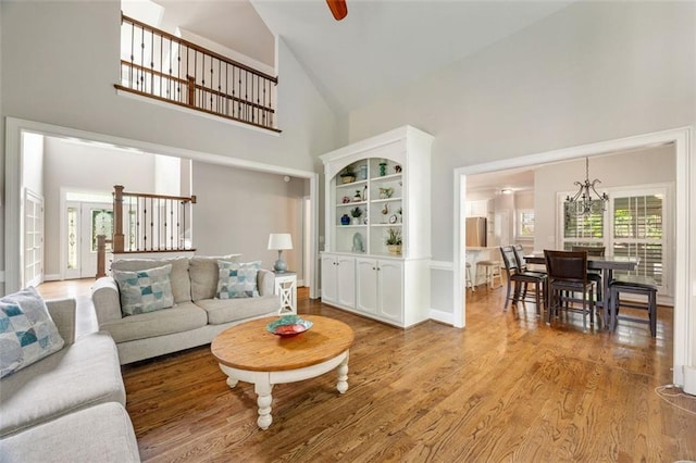 10000 Groomsbridge Rd, Johns Creek, GA 30022 - living area with high vaulted ceiling, wood finished floors, a chandelier, and baseboards